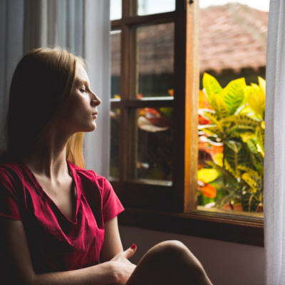woman managing anxiety looking out window